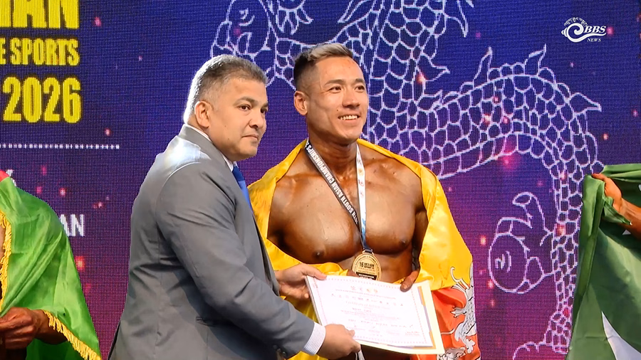 Thinley Dorji holding his medal with pride