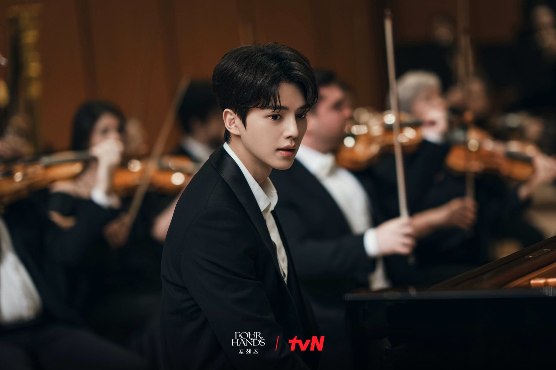 Song Kang performs at a piano recital in formal attire