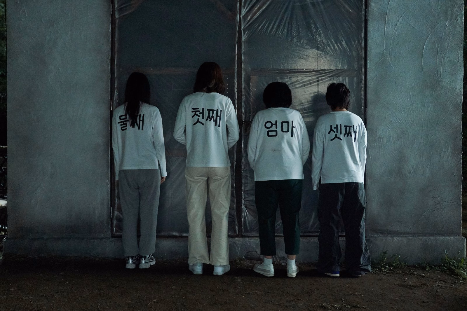 Family members standing in matching t-shirts outside a warehouse