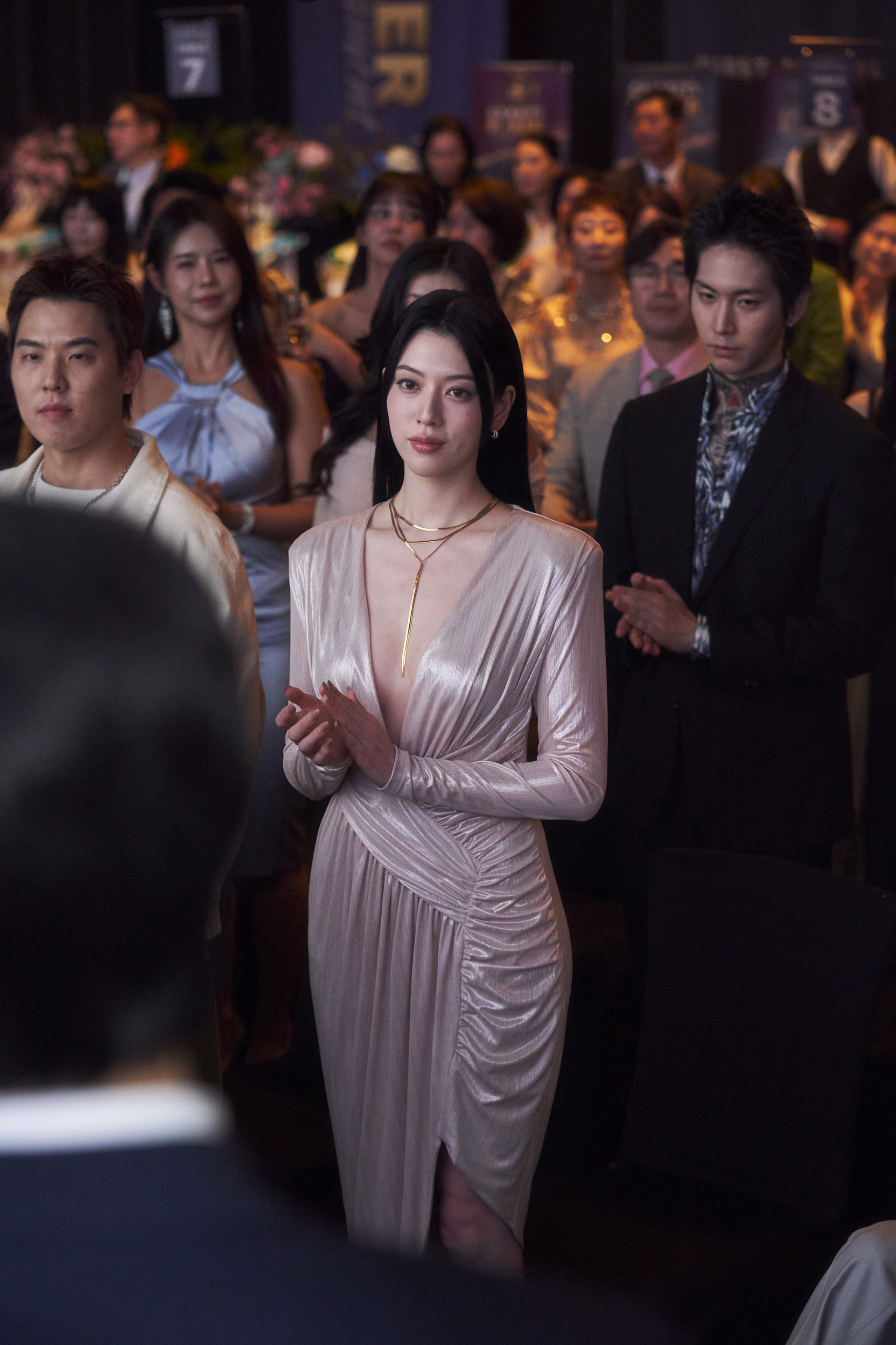 Ayaka Miyoshi in character as Kaneko from Tazza 4, displaying her piercing gaze during the high-stakes game