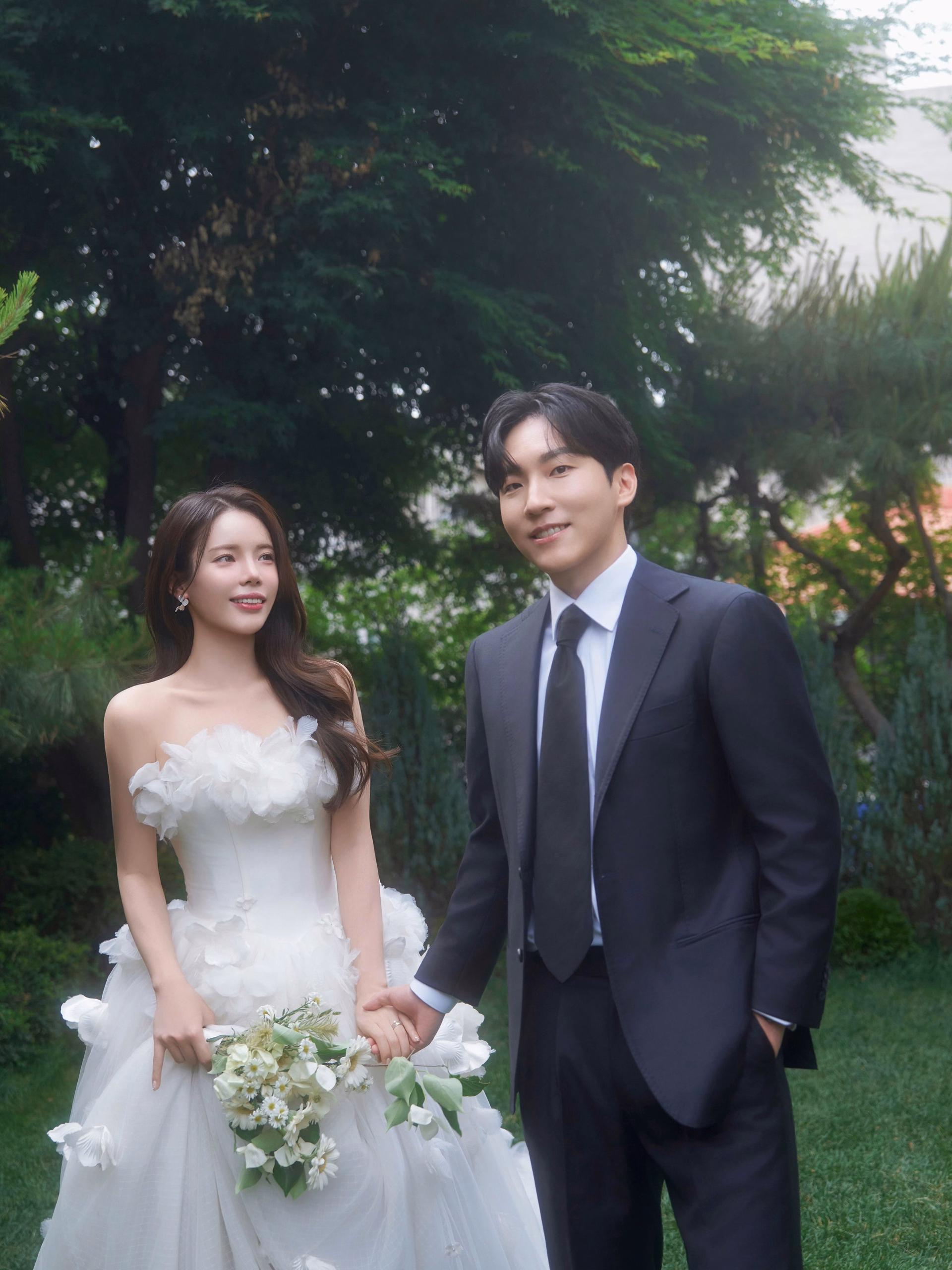 Gunji smiling with her fiancé in a candid engagement photo