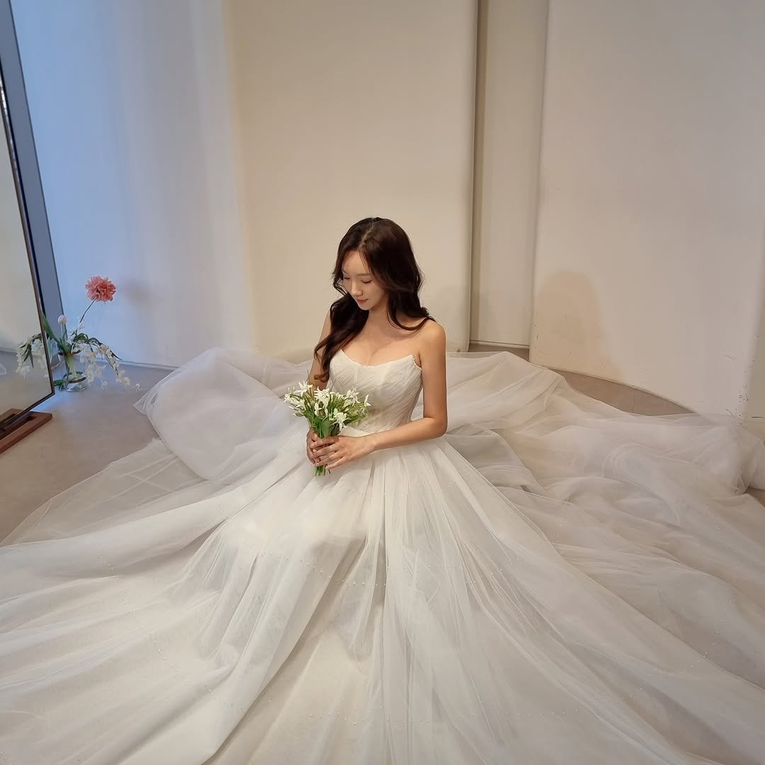 A close-up of Minhee smiling, embodying happiness and love