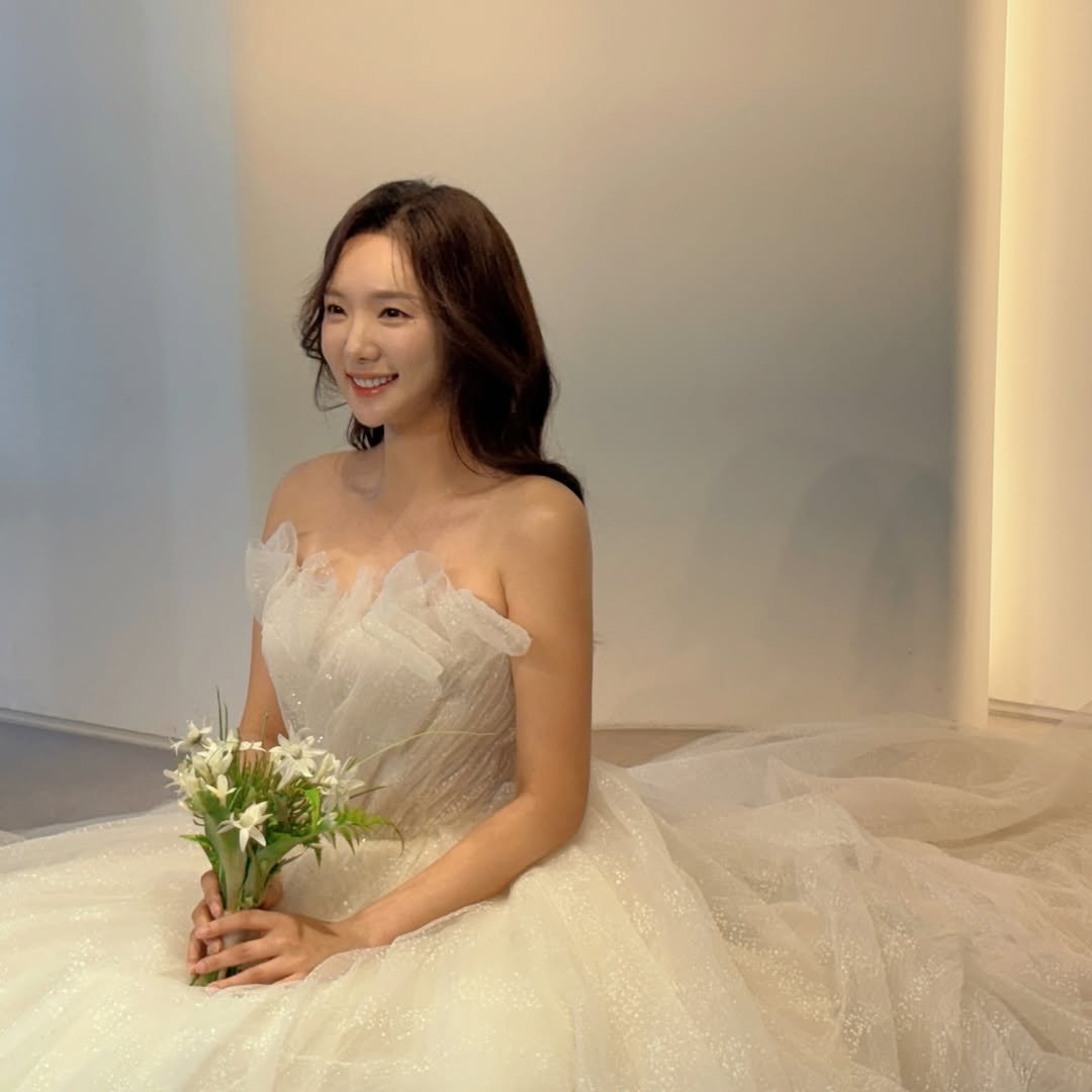 Minhee in her wedding gown, looking radiant and joyful