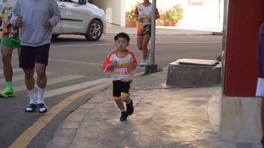 Participants and families celebrating at the finish line of the Thimphu Marathon